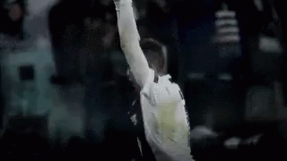 a soccer player in a white shirt with the number 30 on the back