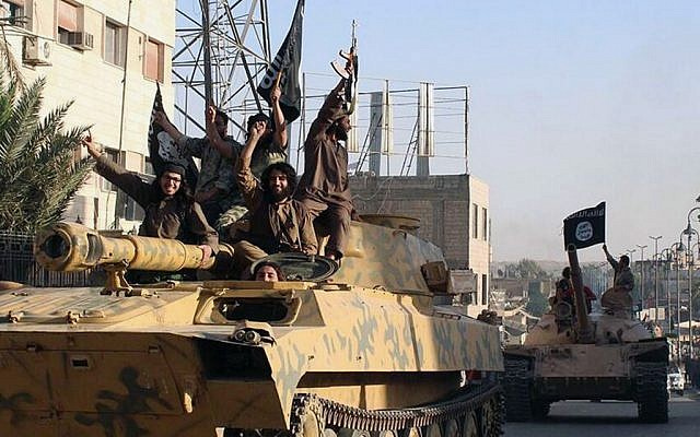 In this undated file image posted on June 30, 2014, by the Raqqa Media Center, fighters from the Islamic State group parade in Raqqa, Syria. (photo credit: AP/Raqqa Media Center)